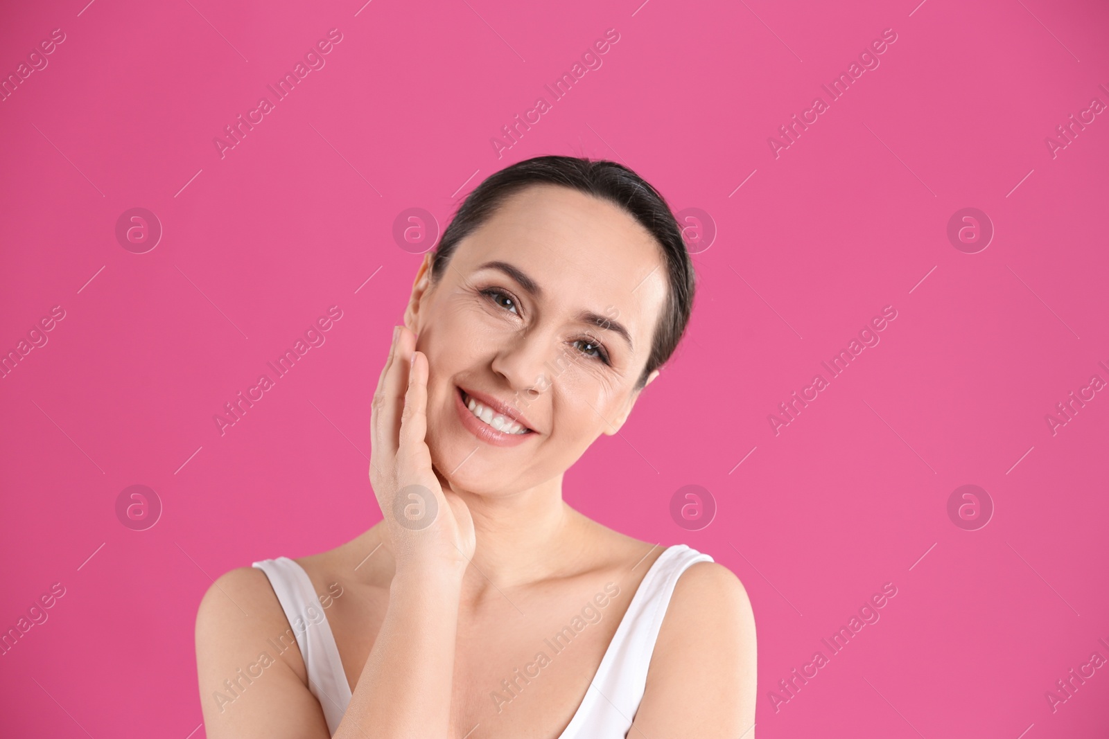 Photo of Portrait of beautiful mature woman on pink background