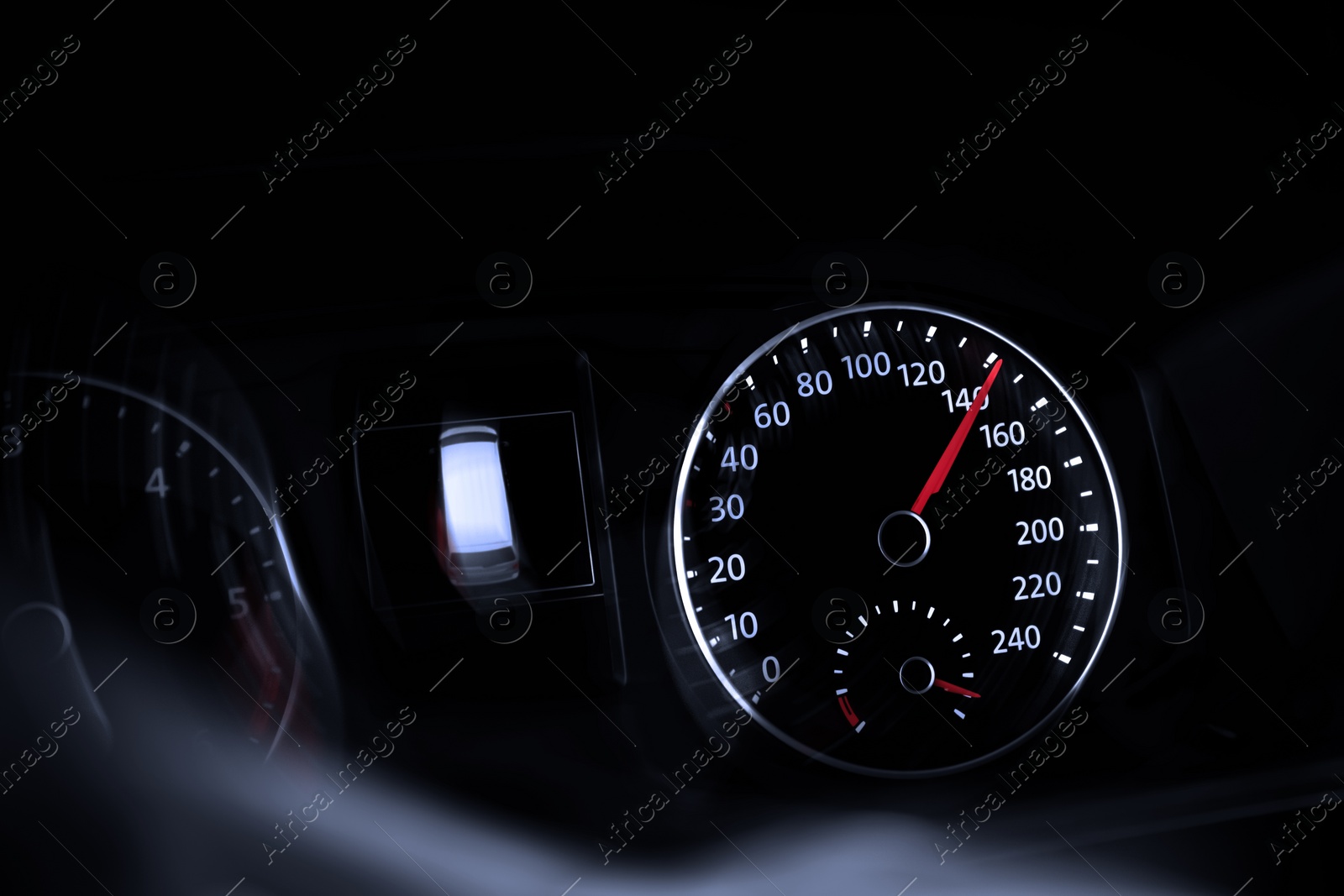 Image of Speedometer on car dashboard, closeup. Motion blur effect