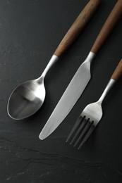 Stylish cutlery on black table, flat lay