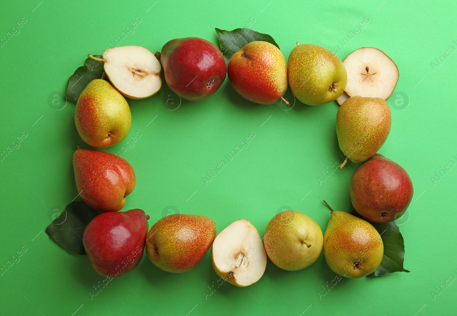 Photo of Ripe juicy pears on green background, flat lay. Space for text