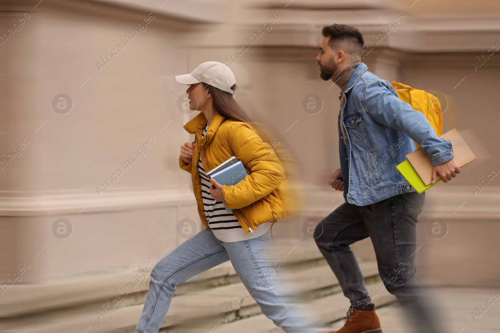 Image of Being late. Students running for class outdoors. Motion blur effect