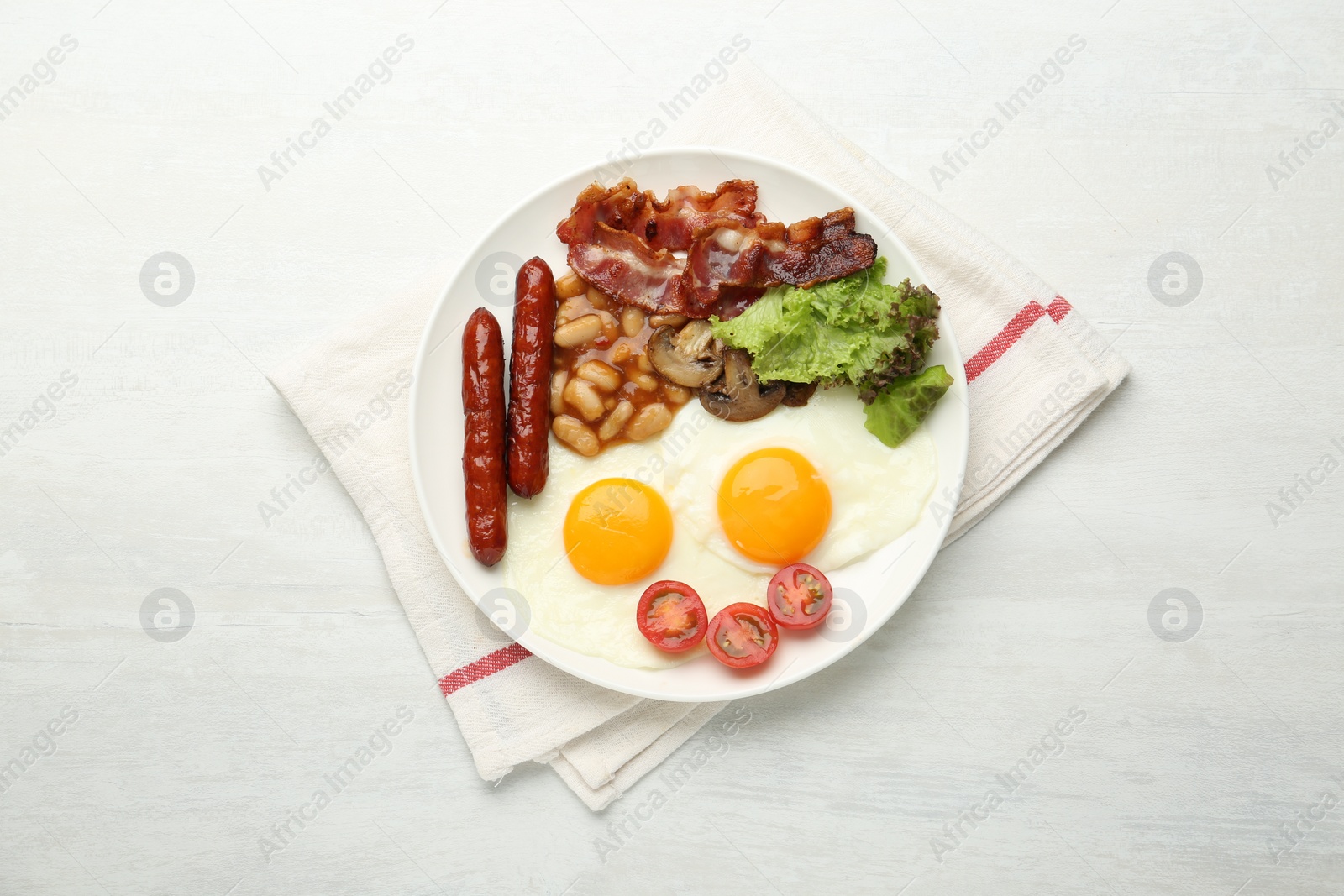 Photo of Delicious breakfast with sunny side up eggs on white table, top view