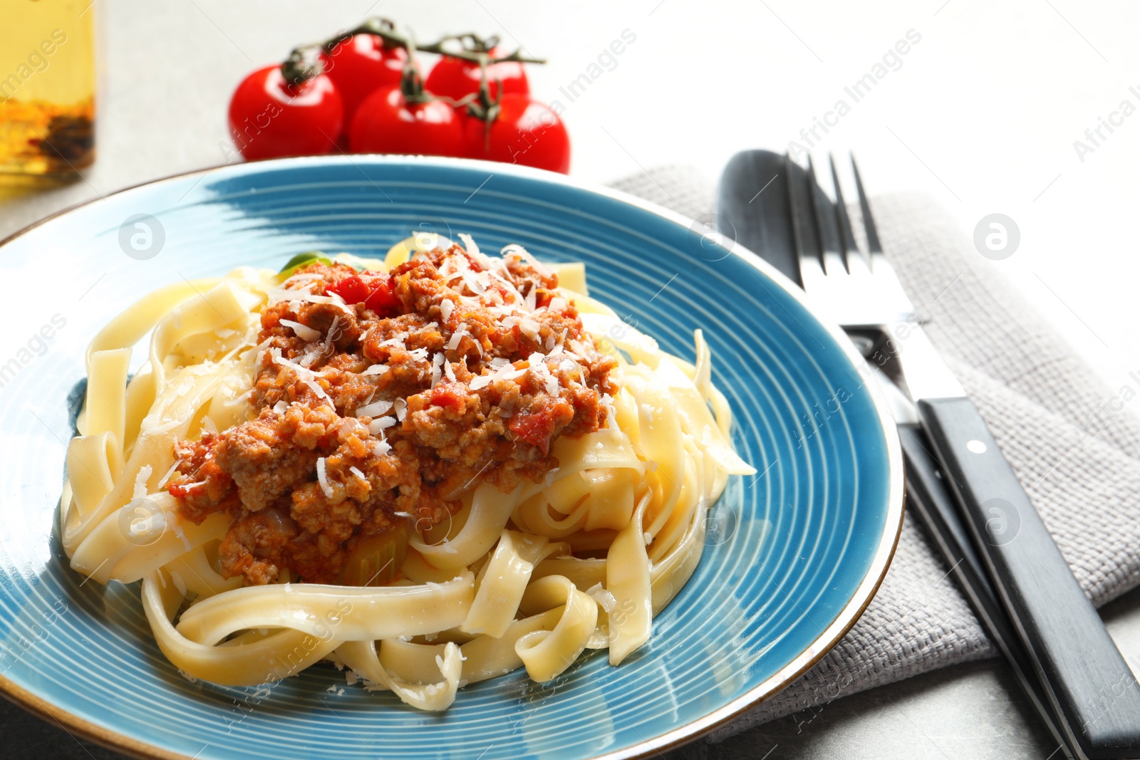 Photo of Plate with delicious pasta bolognese on table