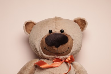 Photo of Cute teddy bear on beige background, top view