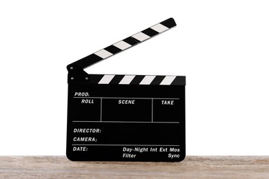 Photo of Movie clapper on wooden table against white background