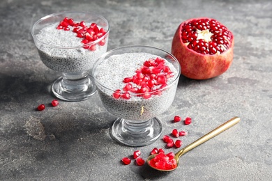 Photo of Tasty chia seed pudding with pomegranate on table