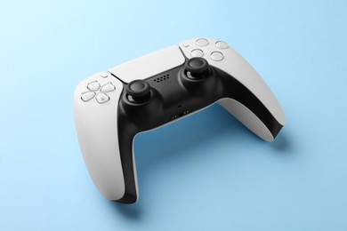 Photo of Wireless game controller on light blue background