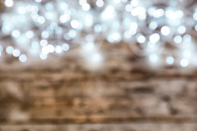 Blurred view of glowing Christmas lights on color background, top view