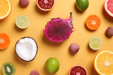 Photo of Different exotic fruits on beige background, flat lay