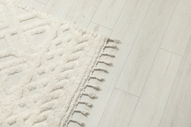 Photo of Beautiful white carpet with pattern on floor, above view. Space for text
