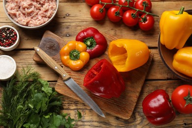Photo of Making stuffed peppers. Vegetables and ground meat on wooden table, flat lay