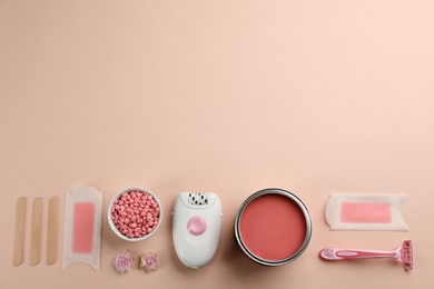 Photo of Set of epilation products on beige background, flat lay. Space for text