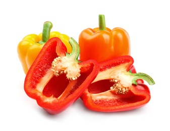 Whole and cut ripe bell peppers on white background