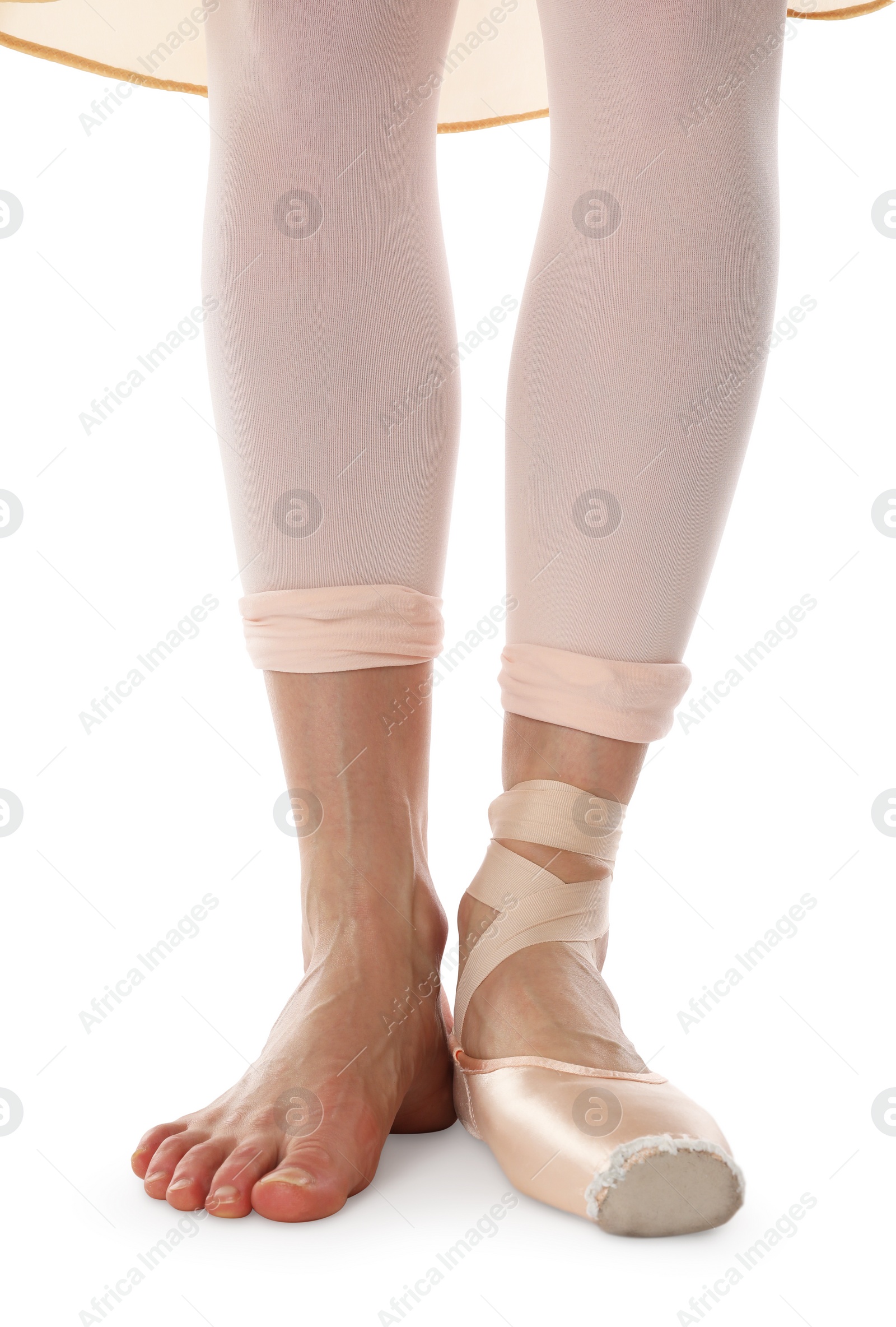 Photo of Ballerina in pointe shoe dancing on white background, closeup