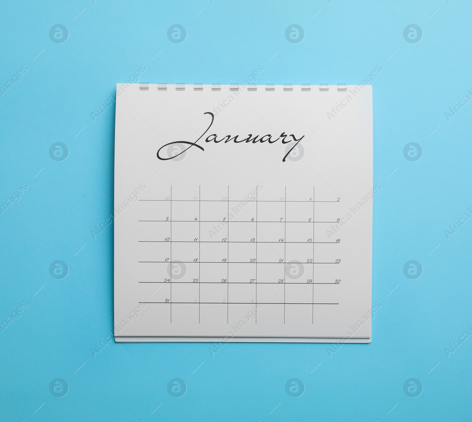 Photo of January calendar on light blue background, top view