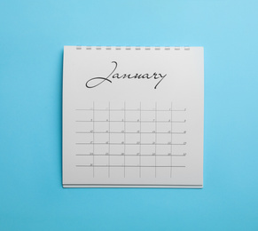 Photo of January calendar on light blue background, top view
