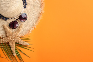 Flat lay composition with stylish hat and beach objects on color background