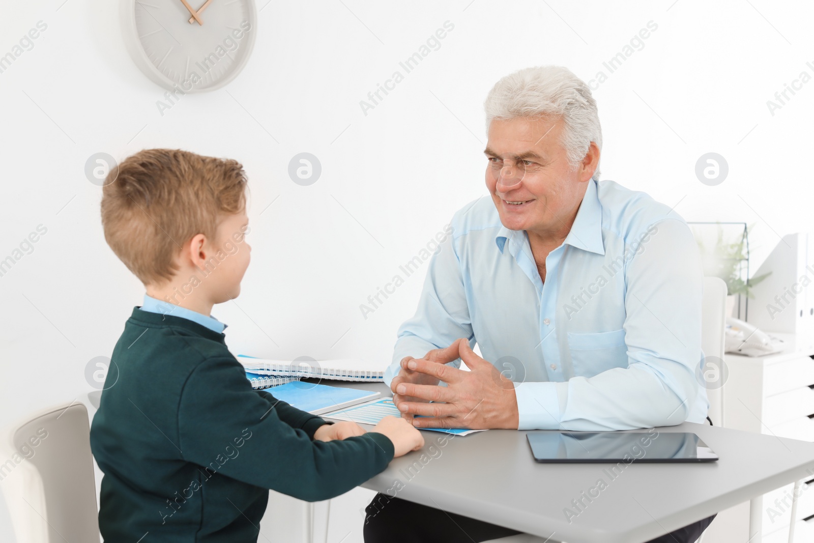 Photo of Little boy having appointment at child psychologist office