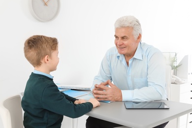 Photo of Little boy having appointment at child psychologist office