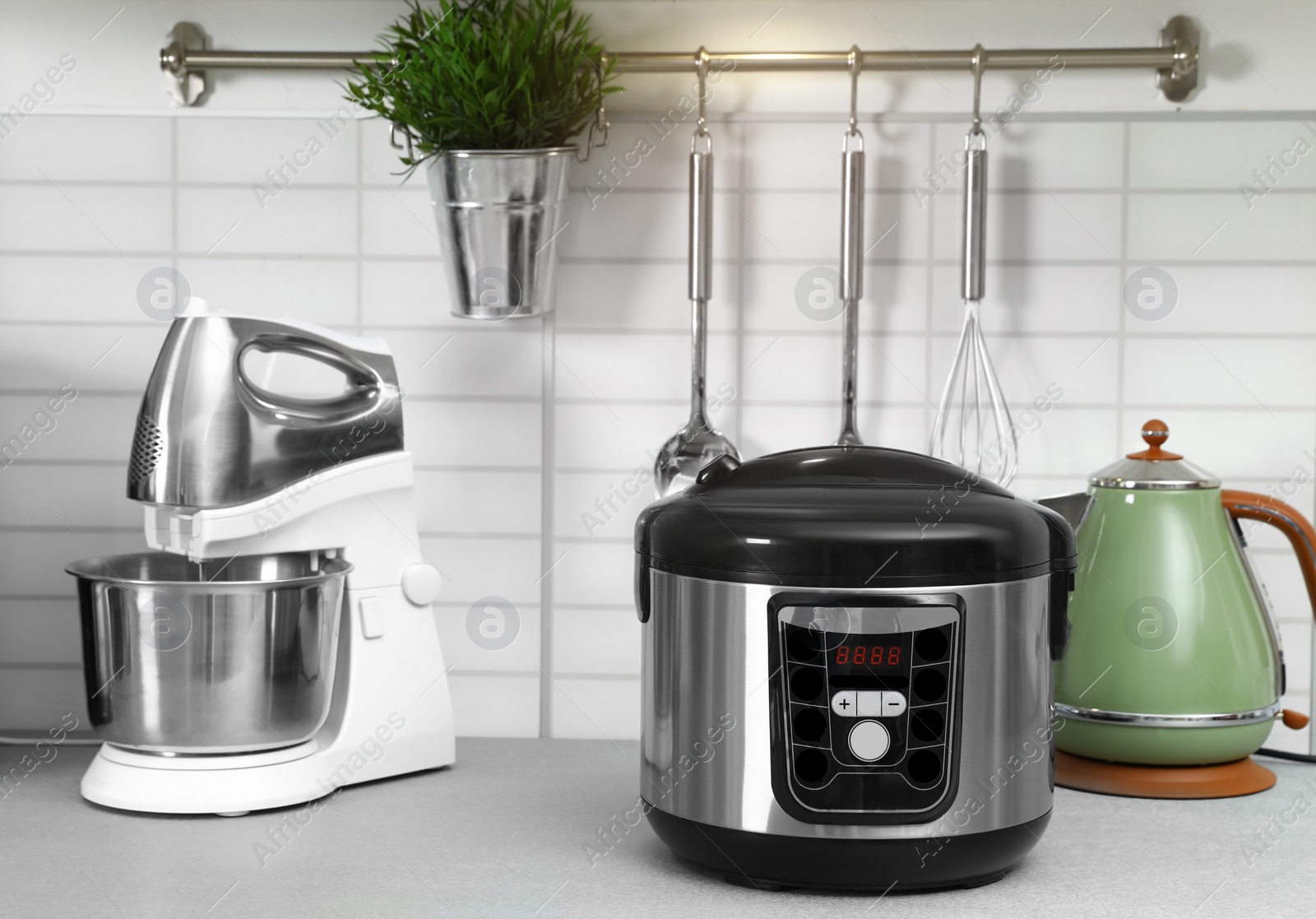 Photo of Modern multi cooker and kitchen appliances on table