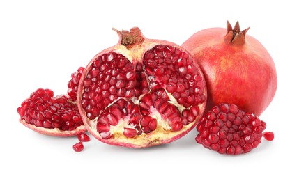 Photo of Half and whole pomegranates isolated on white