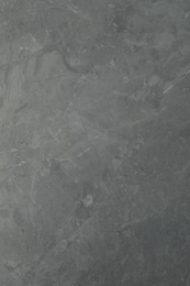 Photo of Texture of light grey marble surface as background, closeup