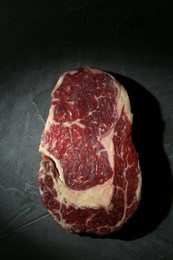 Photo of Piece of raw beef meat on grey table, top view