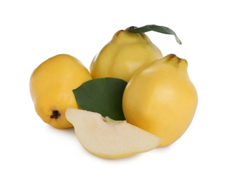 Photo of Whole and cut delicious quinces on white background