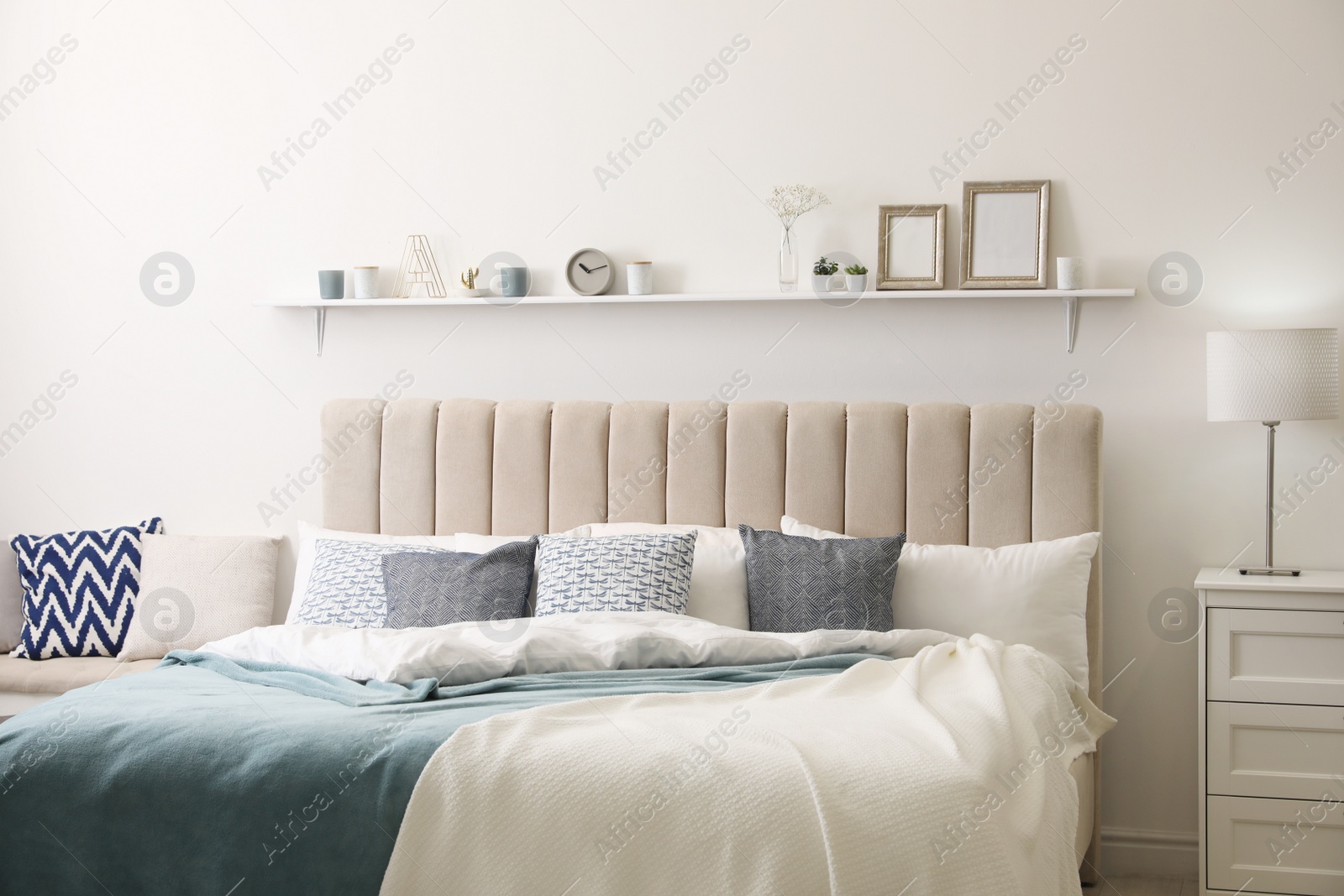 Photo of Comfortable bed with pillows in room. Stylish interior design