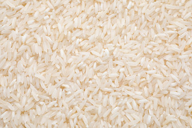 Photo of Pile of polished rice as background, top view