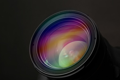 Photo of Lens of professional camera on black background, closeup