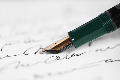 Photo of Writing letter with elegant fountain pen, closeup