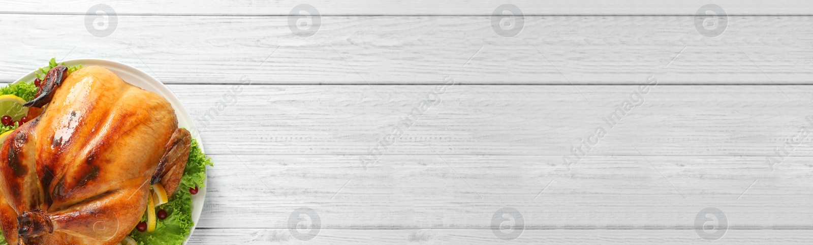 Image of Delicious roasted turkey on white wooden table, top view with space for text. Banner design