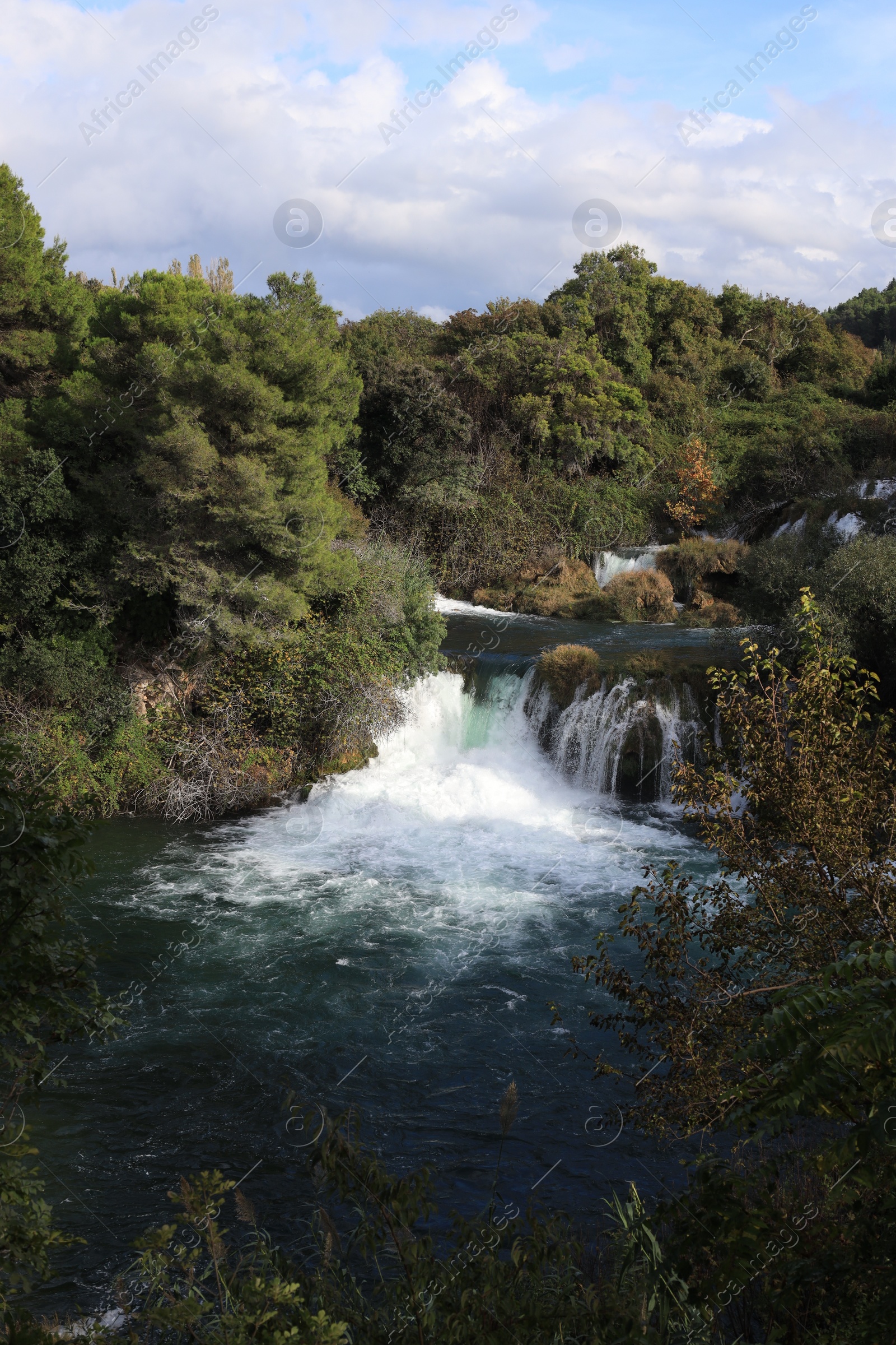 Photo of Picturesque view of beautiful waterfall and rocks outdoors