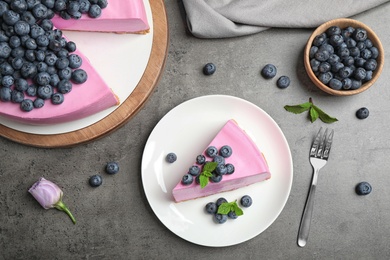 Photo of Flat lay composition of tasty blueberry cake on grey table