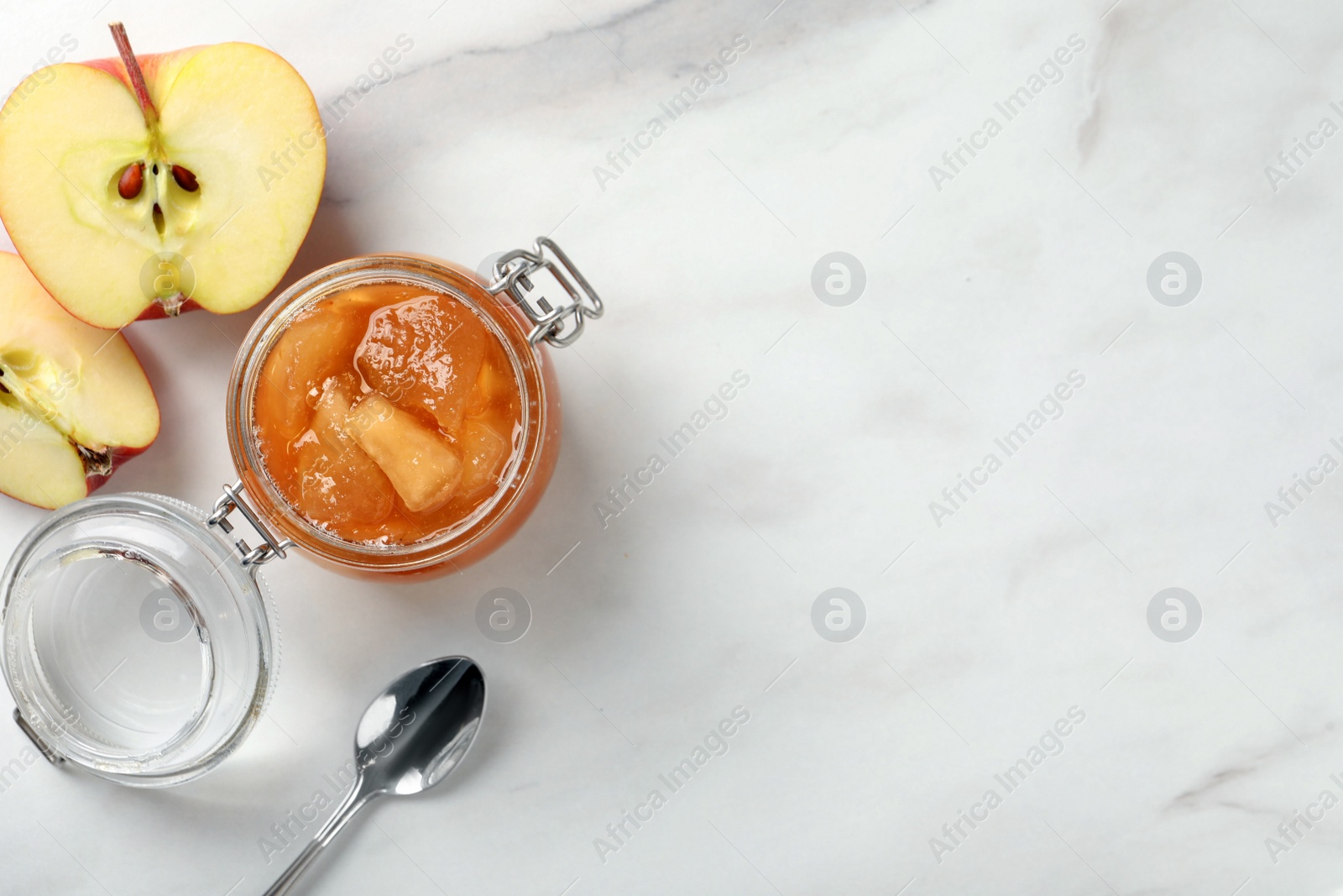 Photo of Delicious apple jam and fresh fruit on white table, flat lay. Space for text