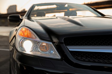 Luxury black convertible car outdoors, closeup view