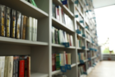 Photo of Blurred view of shelves with books in library