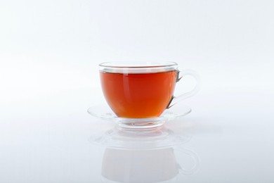 Tasty tea in cup on white background