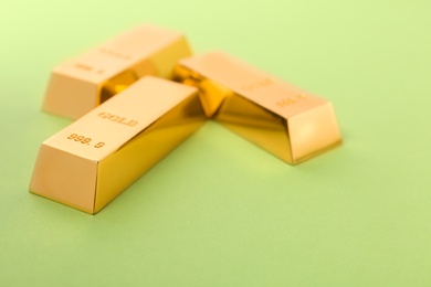 Precious shiny gold bars on color background