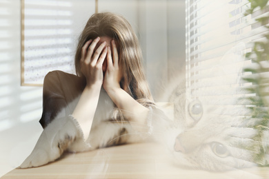 Image of Woman suffering from ailurophobia indoors. Irrational fear of cats
