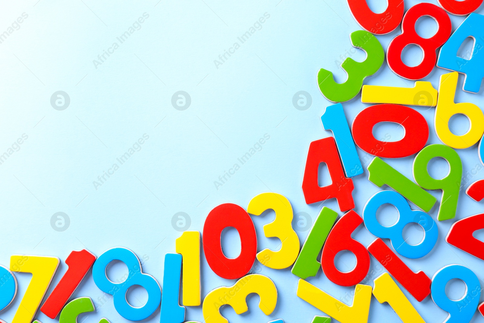 Photo of Colorful numbers on light blue background, flat lay. Space for text