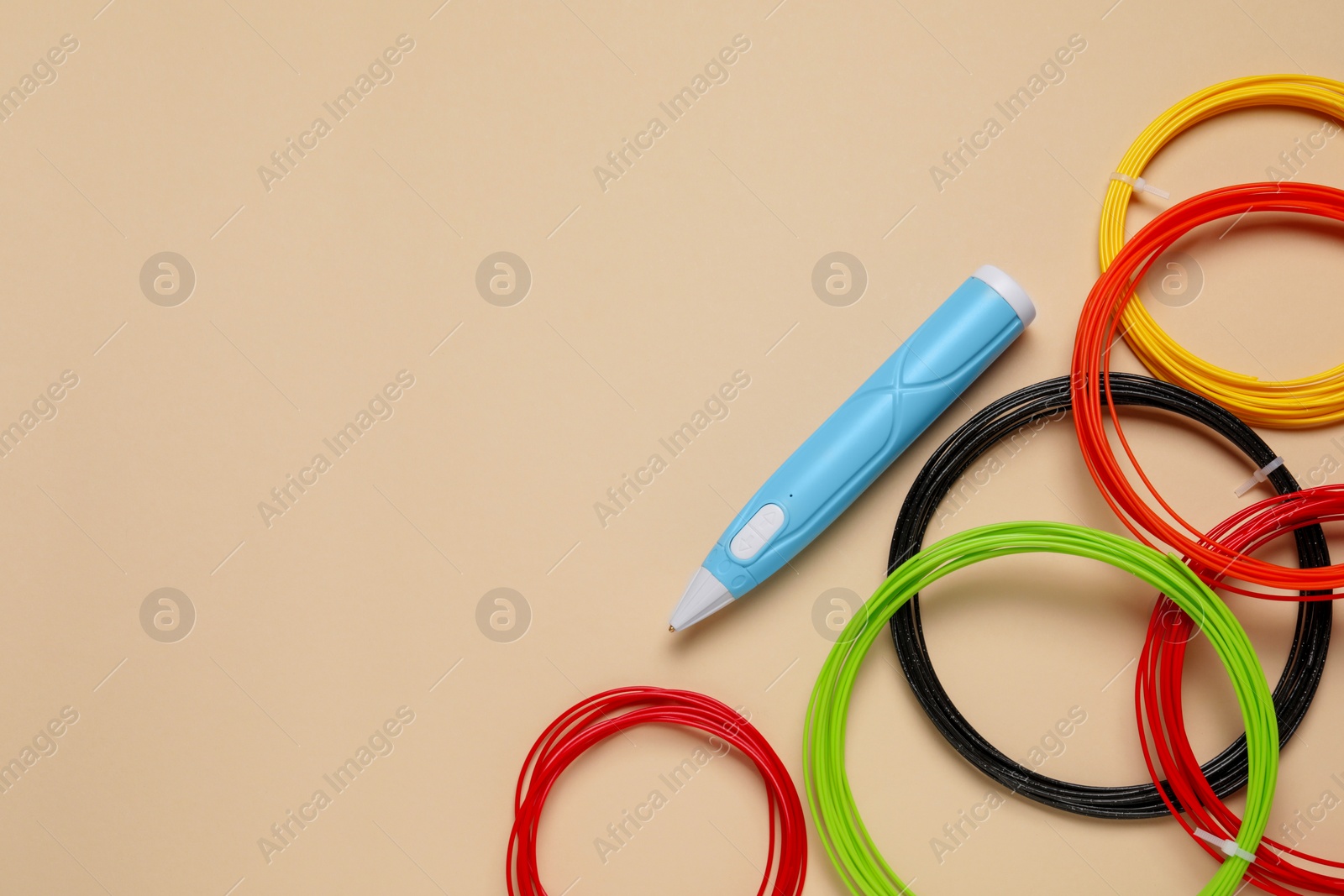 Photo of Stylish 3D pen and colorful plastic filaments on beige background, flat lay. Space for text