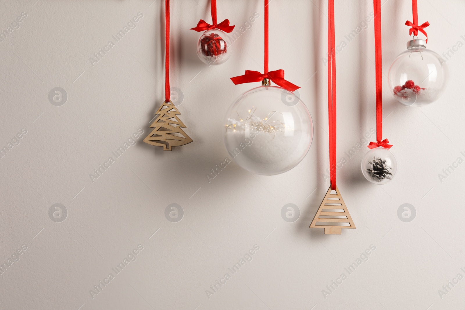 Photo of Decorative snow globes hanging on grey background