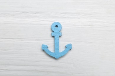 Anchor figure on white textured table, top view