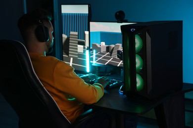 Photo of Man playing video games on computer indoors