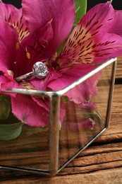 Beautiful luxury engagement ring with gemstone on flower, closeup