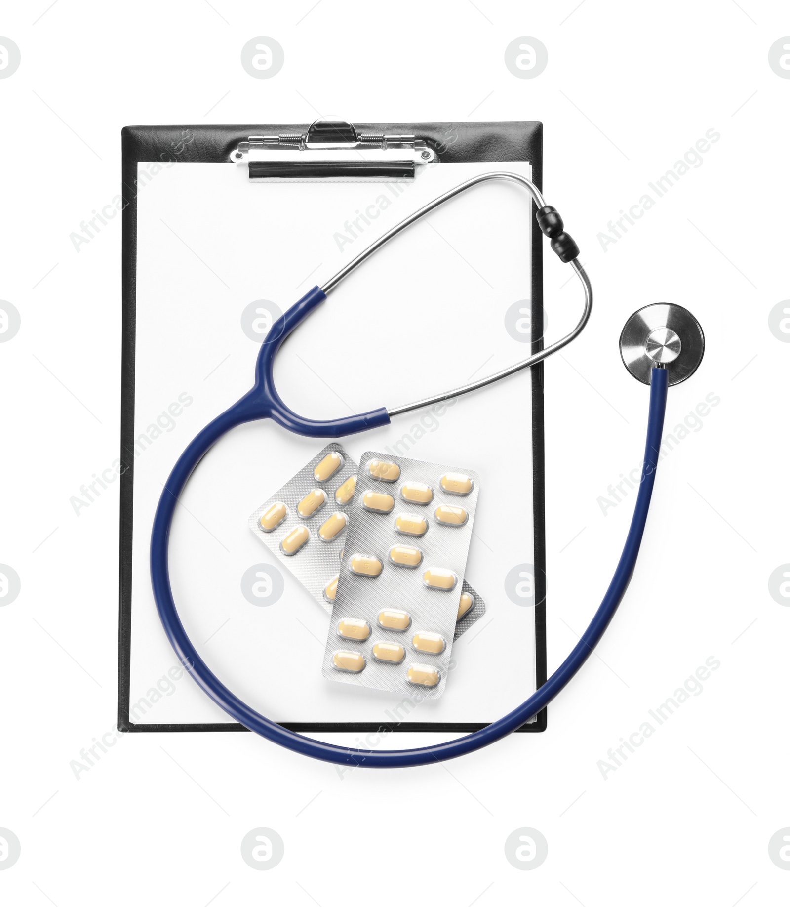 Photo of Clipboard, pills and stethoscope on white background, top view