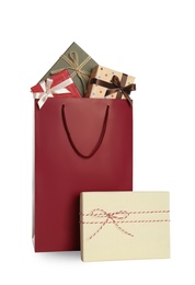 Photo of Paper shopping bag and gift boxes isolated on white