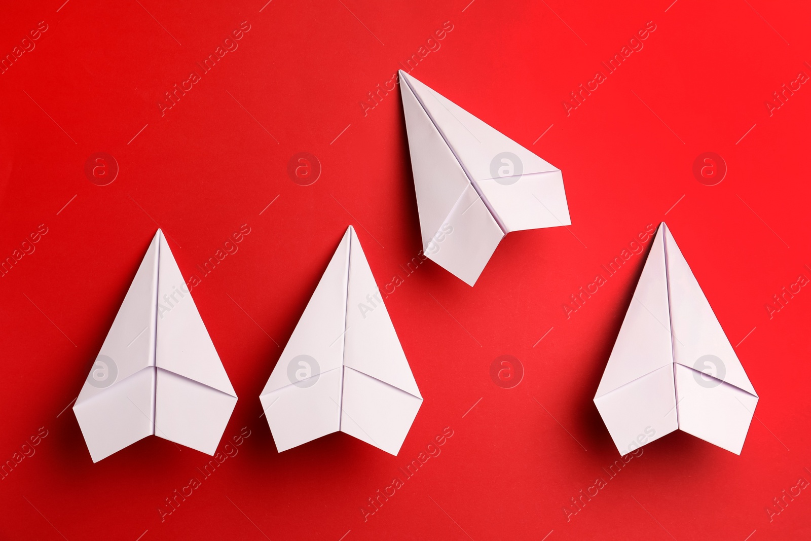 Photo of Flat lay composition with paper planes on red background